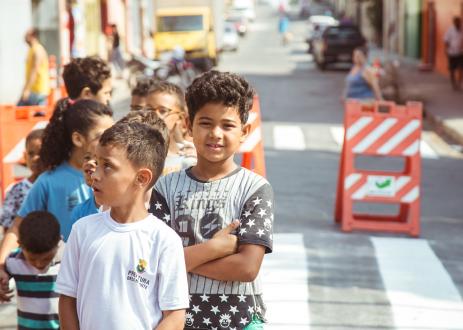 Kids waiting in line on street in Brazil.