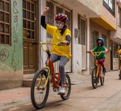 Children biking in line on streets of Calle Colombia.168幸运飞行艇开奖直播