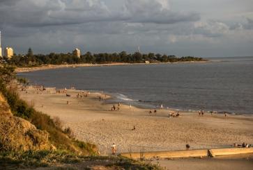 People walk along the beach at Atlántida Departamento de Canelones, Uruguay