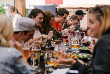 People dining at restaurant table. Photo by Priscilla du Preez/Unsplash